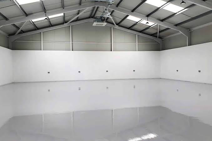 Basic epoxy floor coating in a home garage with a smooth grey finish