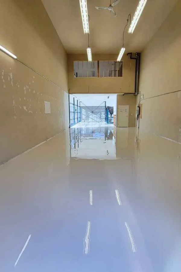 Solid colour neat epoxy floor in a uniform light grey finish